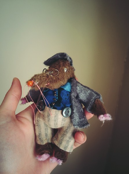 a miniature cloth doll based on the character of mole from the wind in the willows