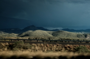 high-contrast lighting image of a desert thunderstorm