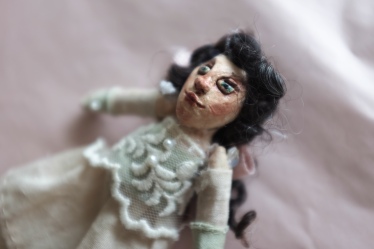 detail of a miniature art doll sculpted from paperclay