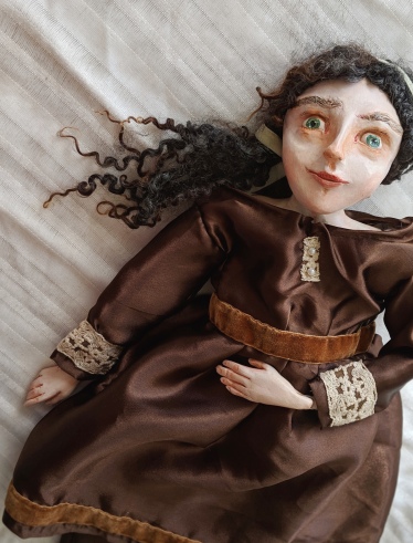jointed art doll sculpted from paperclay, in a brown silk dress