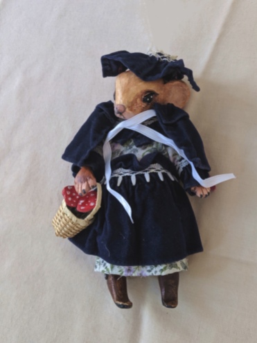 mouse art doll wearing a Victorian velvet cape and bonnet and carrying a basket filled with mushrooms